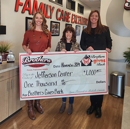 Lynn & Michelle (The Sisters from Brothers) presenting a $1,000 check to the Jefferson Center