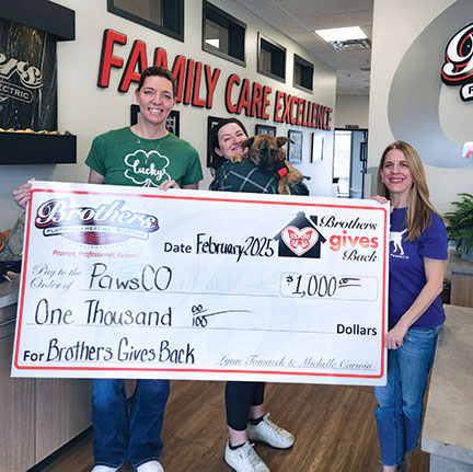 Helping animals in need. Michelle presenting a check for $1,000 to PawsCo